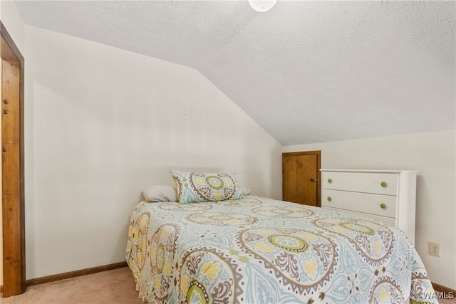 bedroom with a textured ceiling, light colored carpet, and lofted ceiling