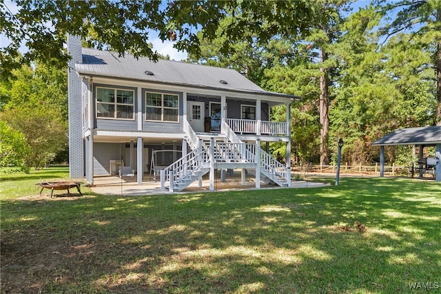 back of property with a patio area and a lawn