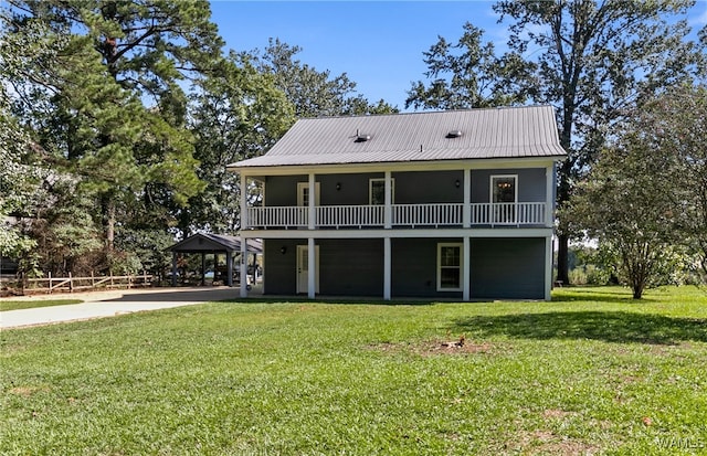 rear view of house featuring a yard