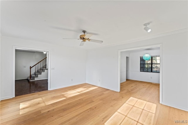 unfurnished living room with wood-type flooring and ceiling fan