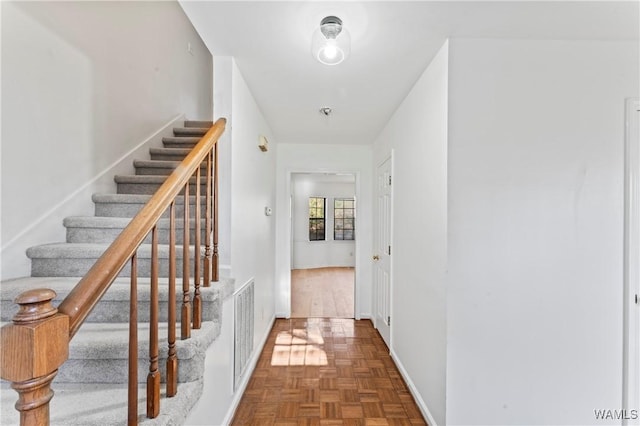 hallway with dark parquet flooring