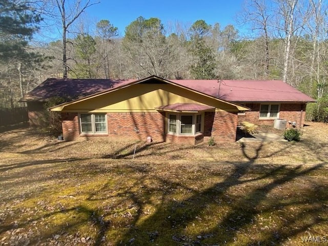 exterior space with central air condition unit and brick siding