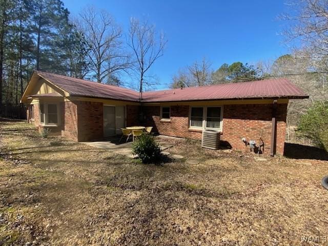 back of property featuring brick siding