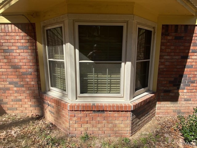 view of exterior entry featuring brick siding