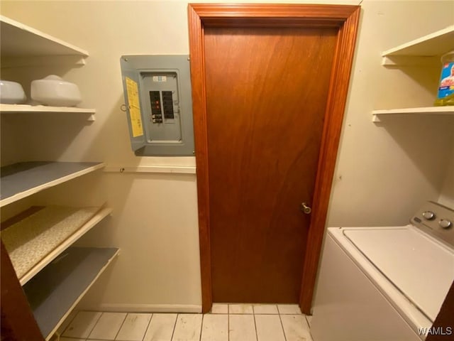 washroom with electric panel, laundry area, washer / clothes dryer, and light tile patterned floors