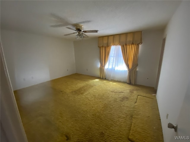 empty room featuring carpet and a ceiling fan