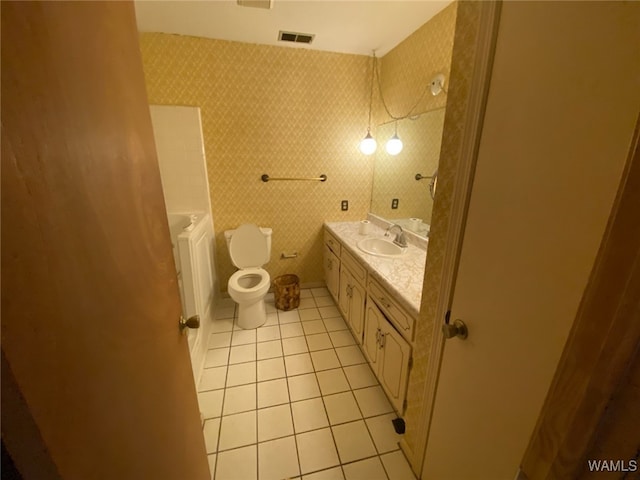 bathroom with tile patterned floors, visible vents, toilet, wallpapered walls, and vanity