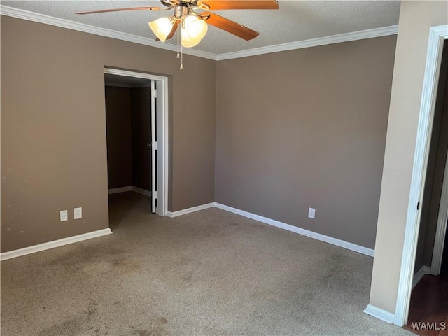 unfurnished room with ceiling fan, ornamental molding, carpet floors, and a textured ceiling