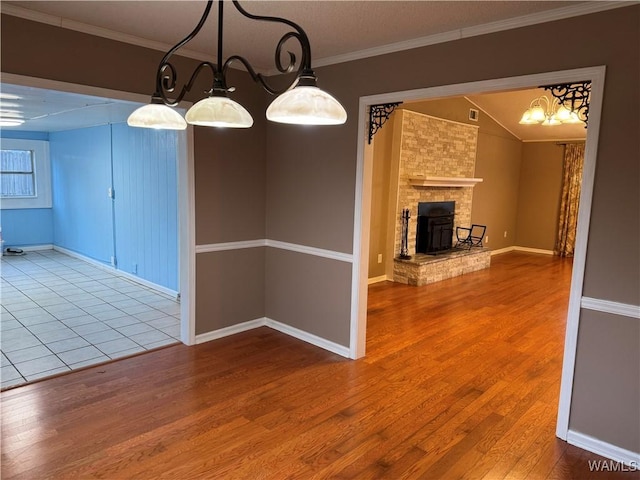 unfurnished dining area featuring ornamental molding, vaulted ceiling, and wood-type flooring