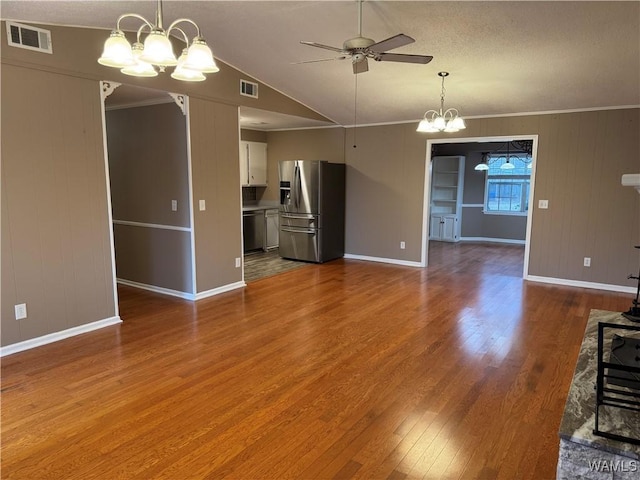 unfurnished living room with crown molding, hardwood / wood-style flooring, ceiling fan with notable chandelier, and vaulted ceiling