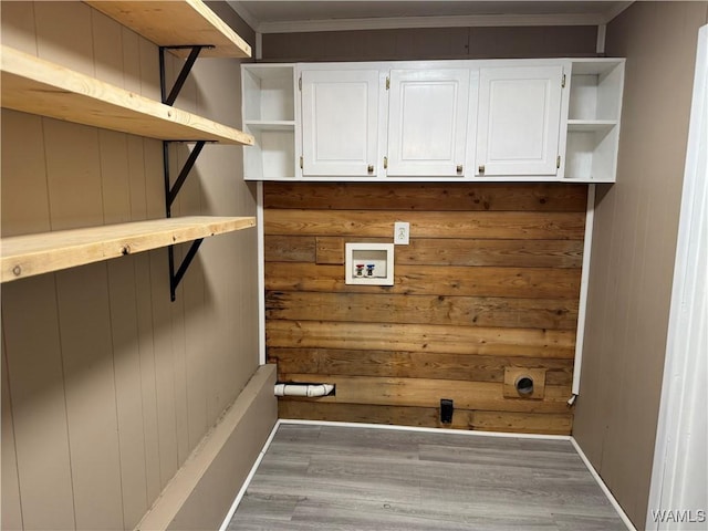 washroom featuring wood walls, washer hookup, light hardwood / wood-style floors, crown molding, and hookup for an electric dryer