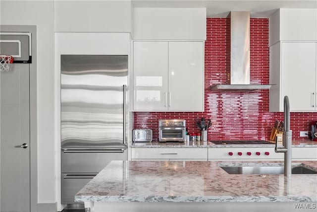 1150 8th St Unit Ph2, Tuscaloosa, AL 35401 - kitchen with stainless steel built in fridge, wall chimney exhaust hood, white cabinets, and modern cabinets