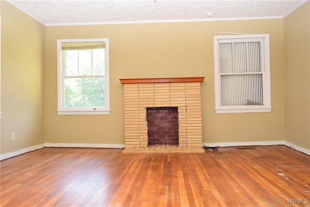 unfurnished living room featuring a fireplace, wood-type flooring, and ornamental molding