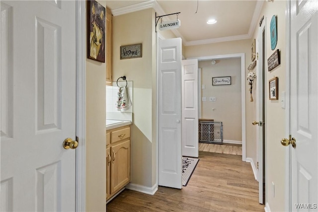 hall featuring ornamental molding, recessed lighting, light wood-style flooring, and baseboards