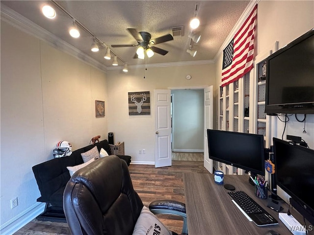 home office featuring visible vents, dark wood-type flooring, ornamental molding, ceiling fan, and a textured ceiling