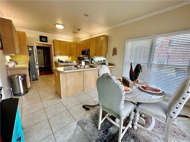 kitchen featuring appliances with stainless steel finishes, a peninsula, light countertops, crown molding, and light tile patterned flooring