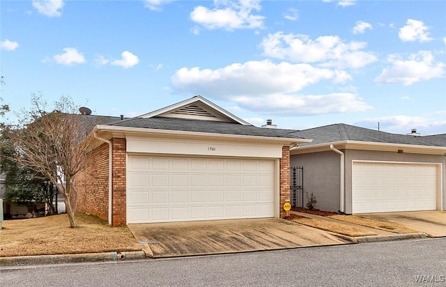 ranch-style home featuring concrete driveway, brick siding, and an attached garage