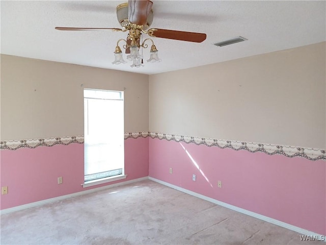 spare room featuring light carpet