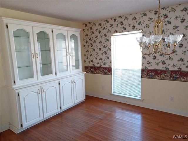 interior space featuring light hardwood / wood-style flooring and a notable chandelier