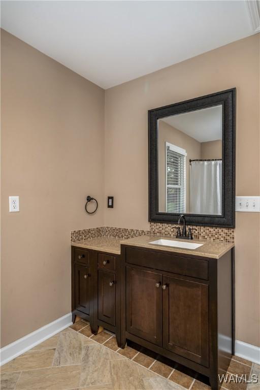 12280 Viewpoint Rd, Northport, AL 35475 - full bathroom featuring tasteful backsplash, baseboards, and vanity