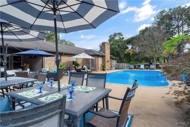 12280 Viewpoint Rd, Northport, AL 35475 - view of swimming pool featuring a patio, outdoor dining space, fence, and a fenced in pool