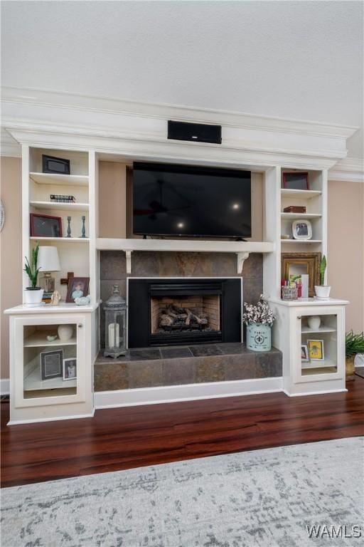 12280 Viewpoint Rd, Northport, AL 35475 - unfurnished living room with a fireplace with raised hearth, built in shelves, wood finished floors, and ornamental molding