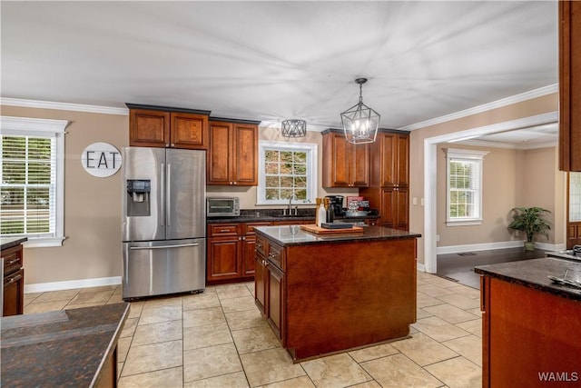 12280 Viewpoint Rd, Northport, AL 35475 - kitchen with a wealth of natural light, stainless steel fridge, pendant lighting, and crown molding