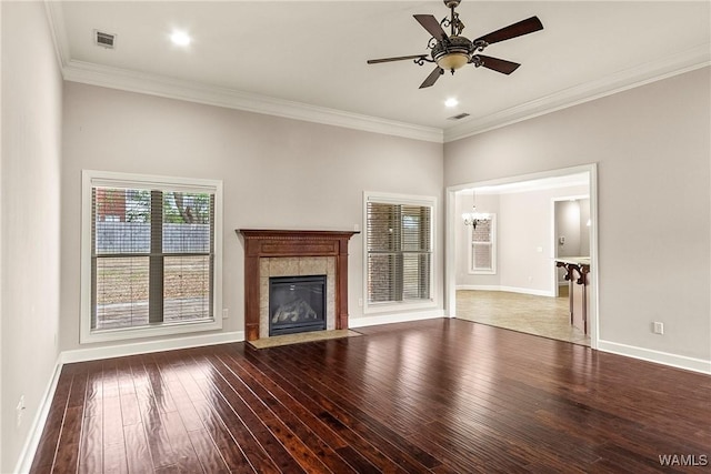 unfurnished living room featuring ceiling fan, ornamental molding, hardwood / wood-style floors, and a tile fireplace