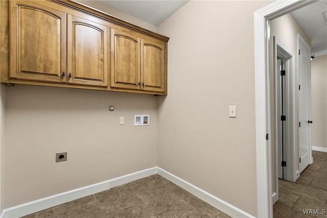 washroom featuring cabinets, electric dryer hookup, washer hookup, and hookup for a gas dryer