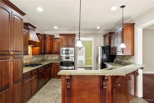 kitchen featuring premium range hood, appliances with stainless steel finishes, sink, hanging light fixtures, and kitchen peninsula