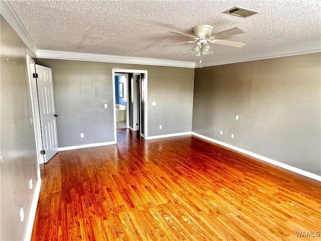 unfurnished room with ceiling fan, wood-type flooring, a textured ceiling, and ornamental molding