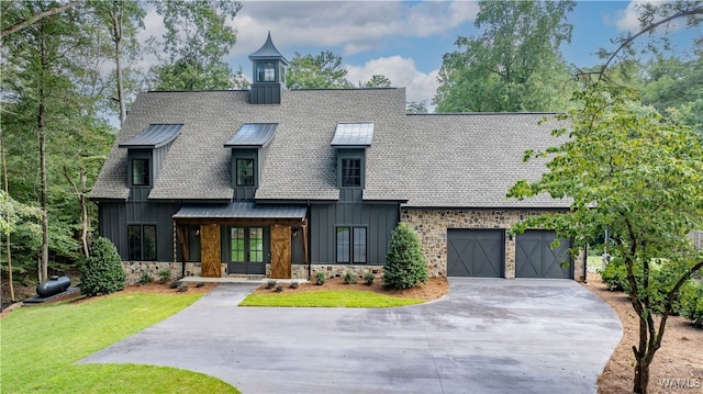 view of front of home with a garage and a front lawn