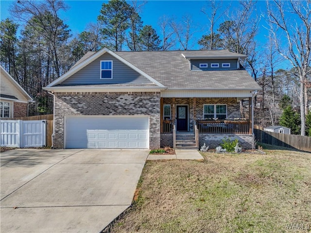 view of front of house with a porch, a garage, and a front lawn