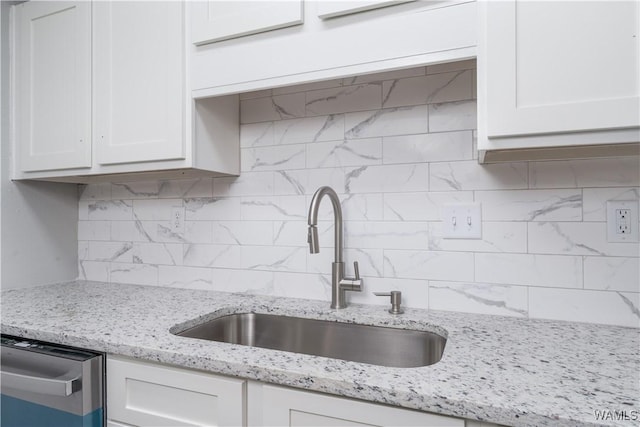 1721 Hackberry Ln Unit 6, Tuscaloosa, AL 35401 - kitchen featuring a sink, backsplash, and white cabinets