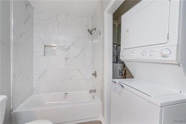1721 Hackberry Ln Unit 6, Tuscaloosa, AL 35401 - bathroom with stacked washer / dryer, toilet, and shower / washtub combination