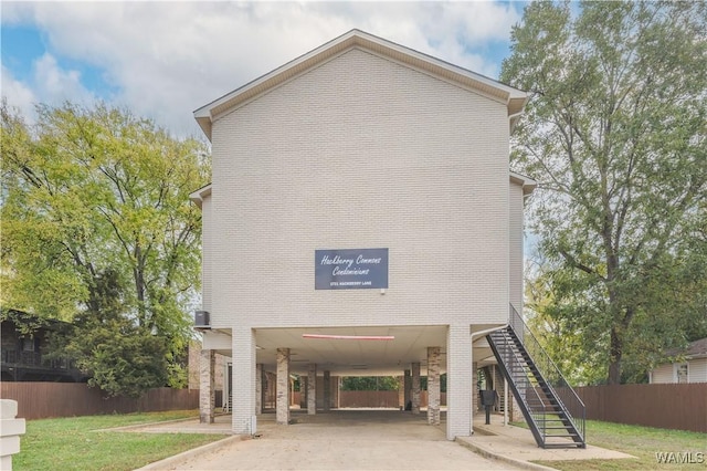 1721 Hackberry Ln Unit 6, Tuscaloosa, AL 35401 - view of property with a carport, fence, stairs, and driveway