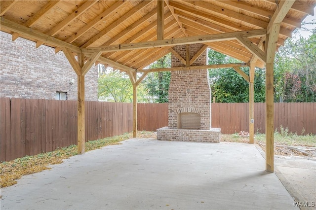 1721 Hackberry Ln Unit 6, Tuscaloosa, AL 35401 - view of patio / terrace with an outdoor brick fireplace and a fenced backyard