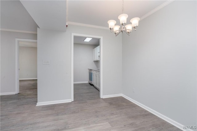 1721 Hackberry Ln Unit 6, Tuscaloosa, AL 35401 - unfurnished dining area featuring wood finished floors, ornamental molding, baseboards, and a chandelier