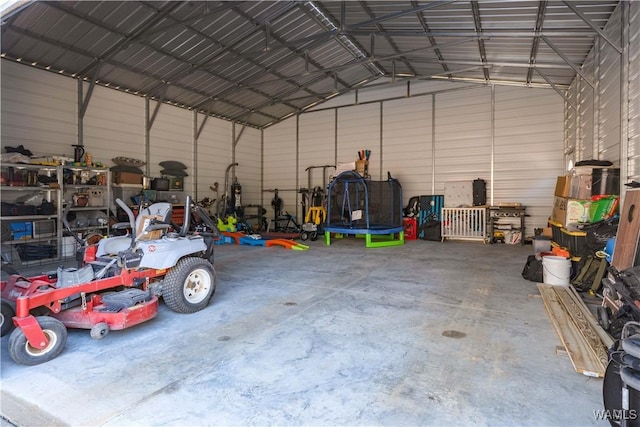 garage with a trampoline and a carport