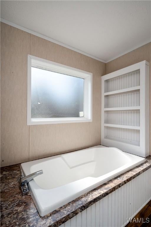 full bathroom with plenty of natural light, a bath, and crown molding