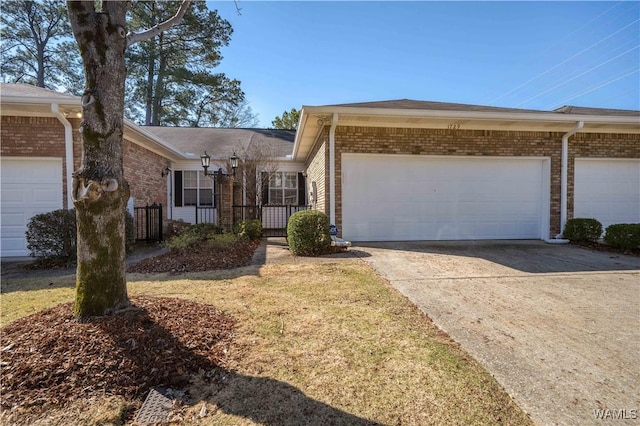 ranch-style home with brick siding, an attached garage, and concrete driveway