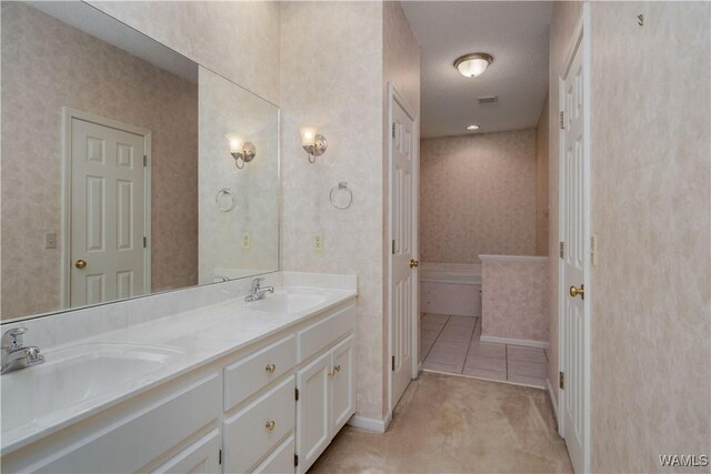 spare room featuring baseboards, light colored carpet, visible vents, and a textured ceiling