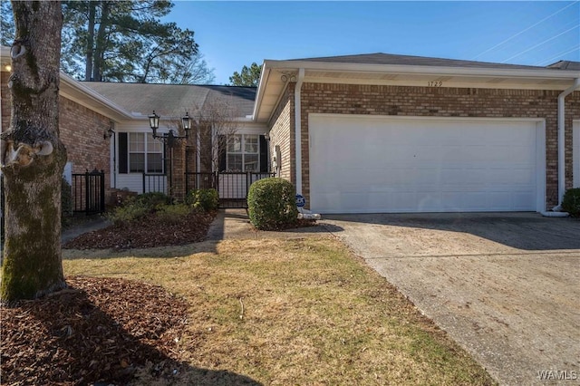 ranch-style home featuring concrete driveway, a garage, and brick siding