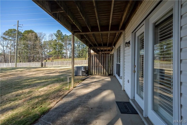 view of patio with central AC unit and fence