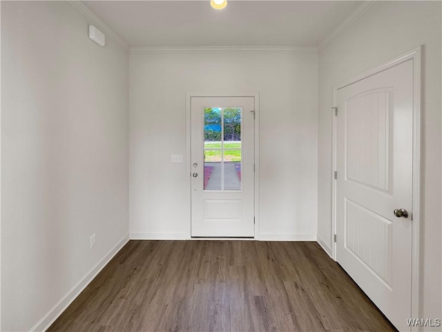 doorway featuring crown molding and dark hardwood / wood-style floors