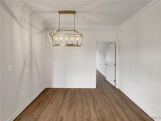 unfurnished dining area featuring crown molding and dark wood-type flooring