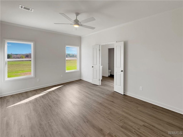 spare room with crown molding, ceiling fan, and dark hardwood / wood-style flooring