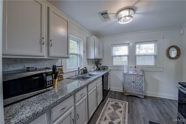 3216 34th Ave, Northport, AL 35476 - kitchen with appliances with stainless steel finishes, a sink, crown molding, dark wood finished floors, and backsplash