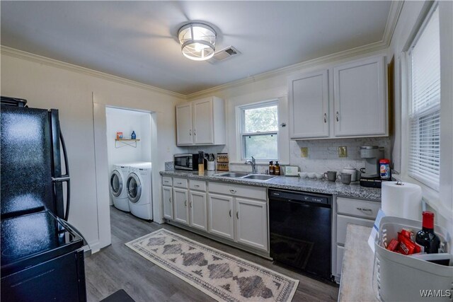 3216 34th Ave, Northport, AL 35476 - kitchen with black appliances, washing machine and dryer, a sink, ornamental molding, and white cabinets