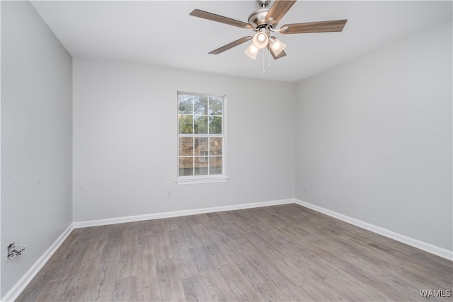 spare room with ceiling fan, baseboards, and wood finished floors